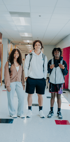 a group of student standing in a hallway