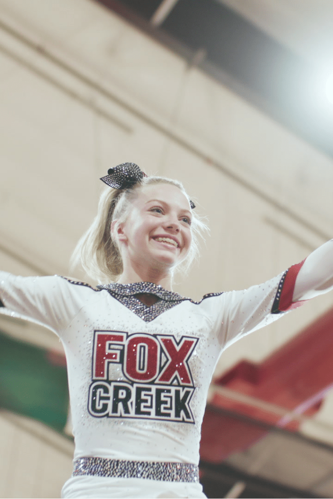 a girl in a cheerleader uniform